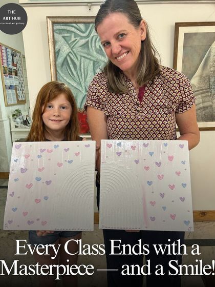 Every class ends with a masterpiece and a smile. A mother and daughter proudly display their matching textured heart paintings, a lovely memory from their time together at the studio.