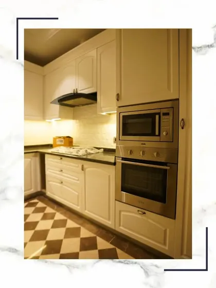 Here you can see how we integrate appliances like the oven and microwave into the cabinetry for a clean, streamlined look. The checkerboard floor adds a classic touch.