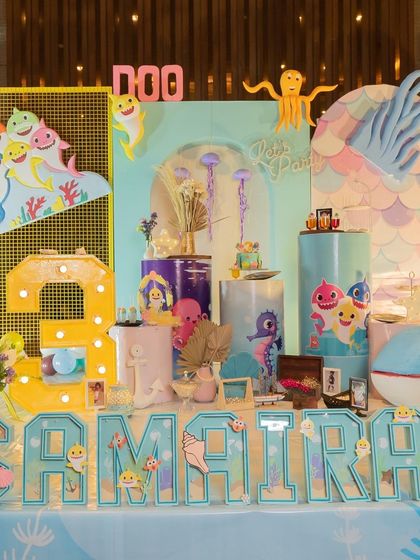 The full view of the Baby Shark party setup. The combination of character cutouts, a light-up number, and themed name blocks created an exciting underwater world for the birthday girl.