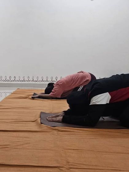 A moment of surrender in child's pose during an Angamardana class, allowing the body to rest and integrate.
