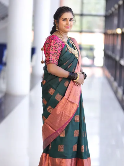 The full look, showing how the necklace complements her beautiful green saree.