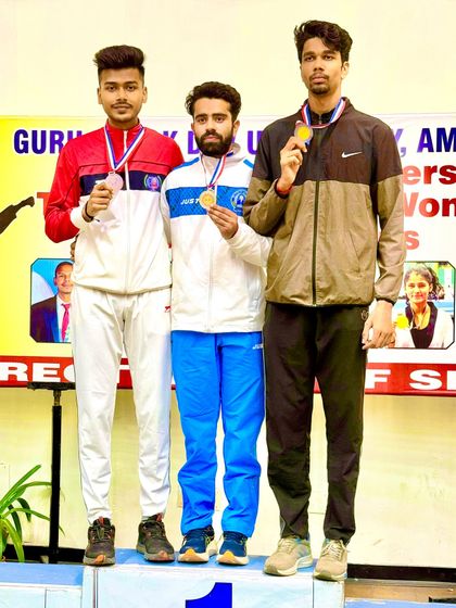 The winners' podium at the All India University Games. Our athlete stands proud after securing a medal against the country's best university talent.