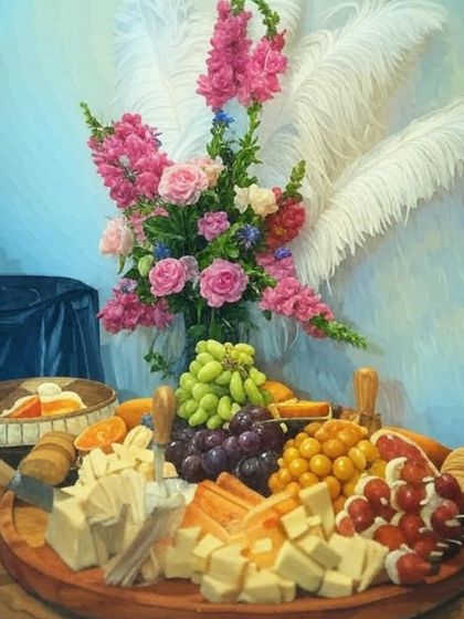 A painterly shot of a classic charcuterie board. This artistic rendering highlights the rich colours of the grapes, cheeses, and floral arrangements, capturing the essence of my "edible art" philosophy.