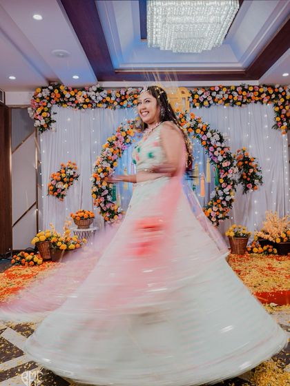 A beautiful motion-blur shot of the bride twirling in her Haldi outfit, capturing the grace and energy of her happiness.