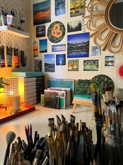 A shot of my studio desk, filled with brushes and paintings.