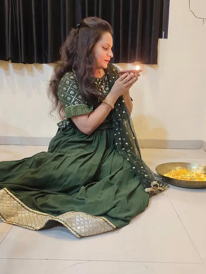 Another beautiful shot of the client enjoying the festival in her lehenga. The design allows for easy movement while still looking elegant from every angle.
