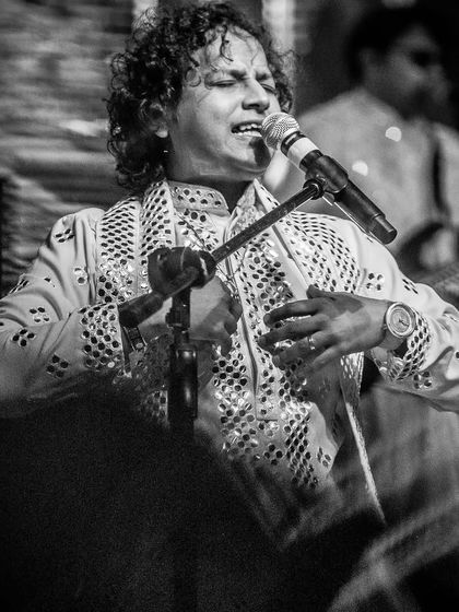A black and white shot of our lead singer, capturing the timeless emotion of a Sufi ballad during a private performance.