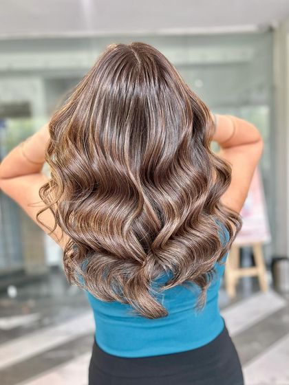 The back view of this soft brown balayage highlights the expert blending and the healthy shine of the hair.