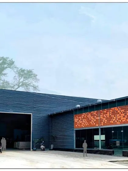 The completed facade of the Om Marble Warehouse in Bangalore. This project demonstrates our ability to create striking commercial buildings that balance industrial functionality with a strong aesthetic identity, using materials like metal cladding and terracotta.