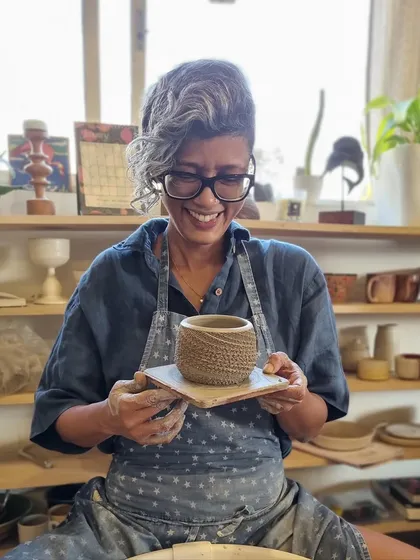 Another shot of me in the studio, smiling with a finished piece. The community and energy here are a constant source of joy and motivation.
