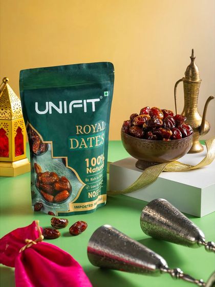 A packet of Unifit Royal Dates, styled with a traditional brass teapot and lanterns for a Ramadan or Eid theme.