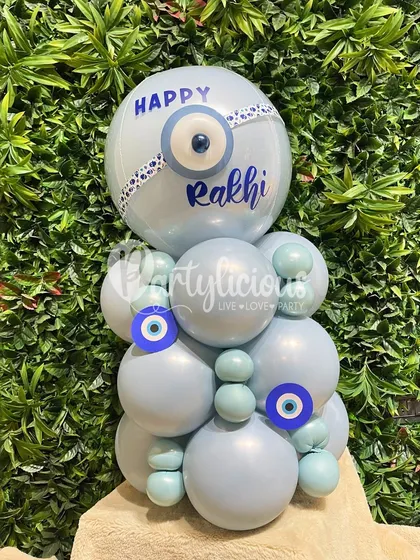 A unique Rakhi greeting. This evil eye-themed balloon arrangement, personalized with a "Happy Rakhi" message, is a modern and stylish way to send love and protection to your sibling.