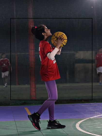 A young girl focuses on her shot during a training session. We create an environment where our female players can transform their game and build confidence.
