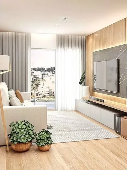 Another view of the compact living room, showing the TV unit and seating arrangement. The design is perfect for small apartments in cities like Mumbai and Thane.