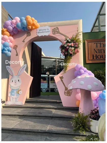 A different angle of the Wonderland entrance, showing a large mushroom prop.