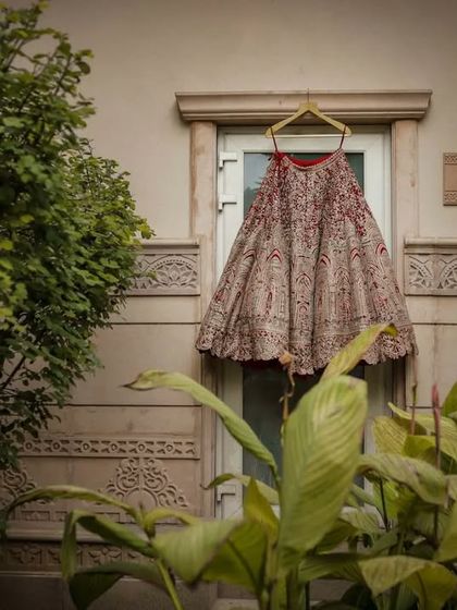 A detail shot of the bridal lehenga, beautifully displayed before the bride gets ready. We appreciate the artistry of bridal couture and capture it as part of the story.