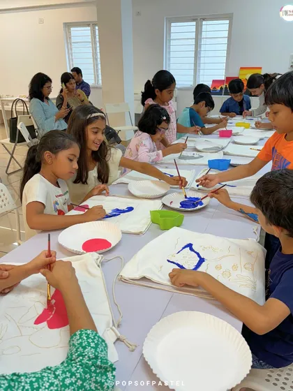 The painting begins. Kids at the sea-themed party start adding color to their pre-drawn bag designs.