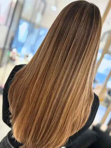 Here is the same honey blonde balayage, styled straight. This shows how the color looks just as seamless and beautiful without waves, highlighting the glossy, healthy finish.