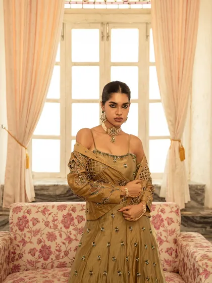 Using the soft light from a window, this shot highlights the delicate embroidery and modern silhouette of a fusion-wear lehenga. The focus is on the interplay of light, texture, and the model's confident expression.
