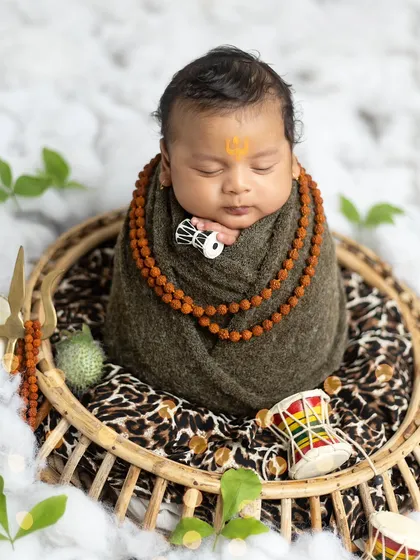Holding a tiny damaru, this little one looks absolutely divine in the Mahadev setup. I ensure every prop is baby-safe and comfortable.