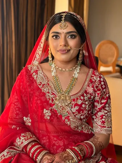 A direct, confident gaze from our royal bride. The makeup is bold and defined, with a sharp wing and perfectly sculpted features that command attention.