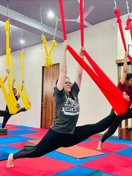 Aerial yoga is where strength meets grace. We guide you to achieve poses you never thought possible, like this full split in the hammock, which builds flexibility and confidence while being gentle on your joints.