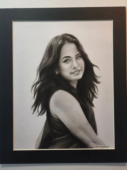 The finished portrait in a black frame, ready to be displayed.