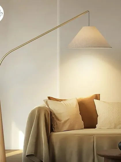 An elegant floor lamp with a wooden base and a sweeping arm, ideal for placing over a sofa.