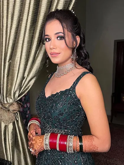 A gorgeous reception bride. I created a soft glam look with a defined eye that complemented her beautiful green gown and traditional red bangles.