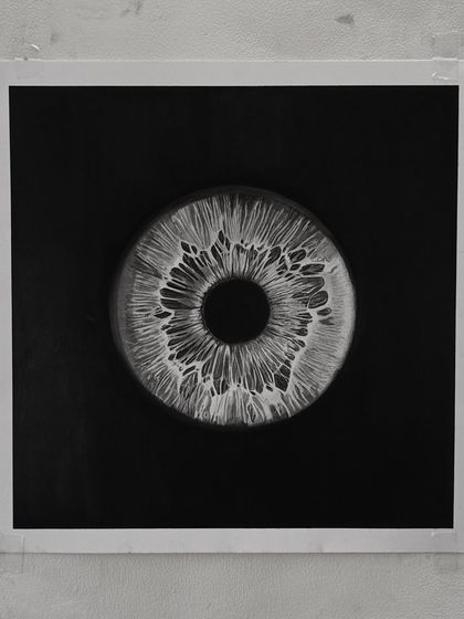 The "Iris" drawing on the wall. The circular shape within the square format creates a strong focal point.