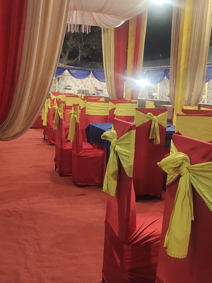 We take care of the seating arrangements too. Here you can see the guest dining area set up with clean table linens and decorated chair covers.