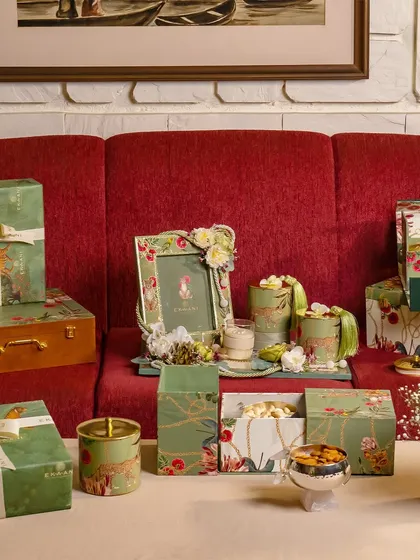 This is a glimpse into the lush world of my Tales of Tropic collection. I've arranged custom-designed boxes, a photo frame, and artisanal jars on a table to show how the vibrant botanical theme creates a cohesive and exotic feel for a destination wedding.
