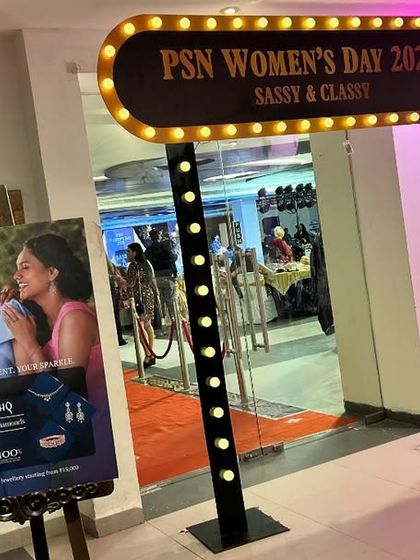 An illuminated marquee sign at the entrance to the PSN Women's Day event. This custom sign, along with branded posters, welcomes guests and reinforces the event's theme from the moment they arrive.
