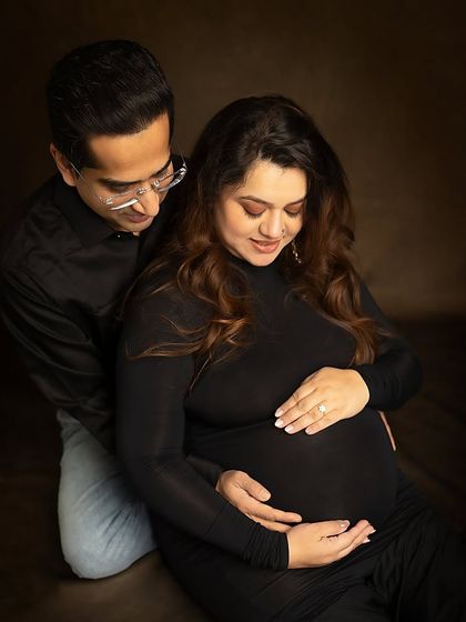 Seated together, sharing a moment of quiet reflection. The low-key lighting creates an intimate and soulful mood.