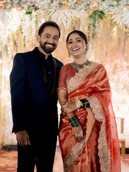 A beautiful portrait of the happy couple under a floral arch.