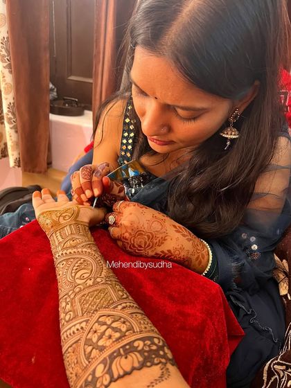 Here I am, in my element, adding the final touches to a friend's bridal mehendi. I pour all my love and focus into every line.