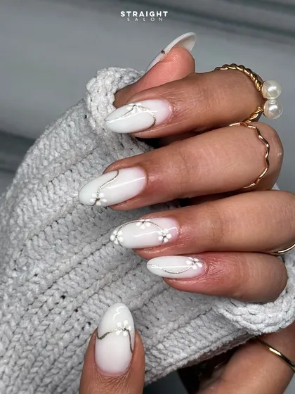 A close-up of the beautiful hand-painted floral and silver line work. The details are subtle, creating a sophisticated and timeless manicure.