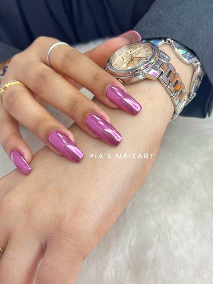 Chrome nails are trending, and this vibrant magenta chrome shows why. The high-shine, metallic finish is impossible to ignore.
