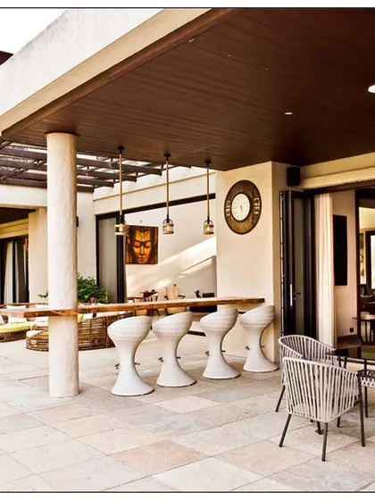 A wider view of the Khandala patio, showing the different zones we created for dining and lounging. The design uses natural materials and earthy tones to complement the surrounding nature.