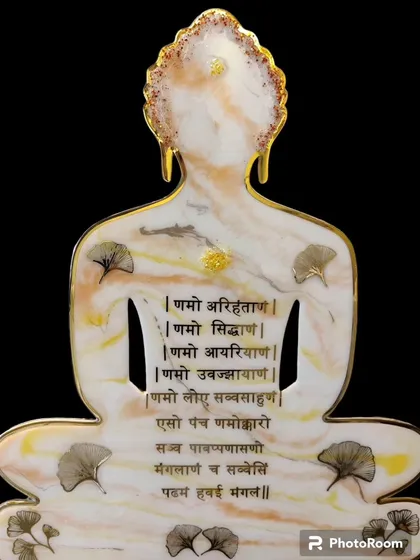 Another view of the Buddha-shaped Navkar Mantra wall decor. The marble effect and delicate leaves create a serene and peaceful vibe.