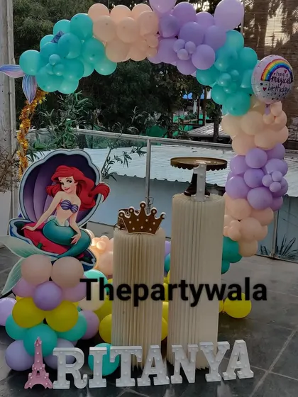 A lovely mermaid theme with a pastel balloon arch. The Ariel cutout and crown prop make it perfect for a little princess of the sea.