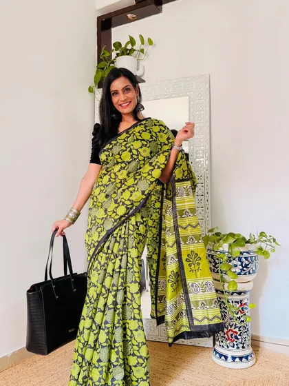 A lime green and black block-print style saree that is both cheerful and professional. It's a great way to add some personality to your work attire.