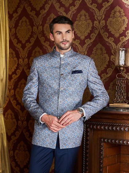 A slightly different angle of the royal blue bandhgala, highlighting the sheen of the fabric and the sharp cut of the jacket against a luxurious backdrop.