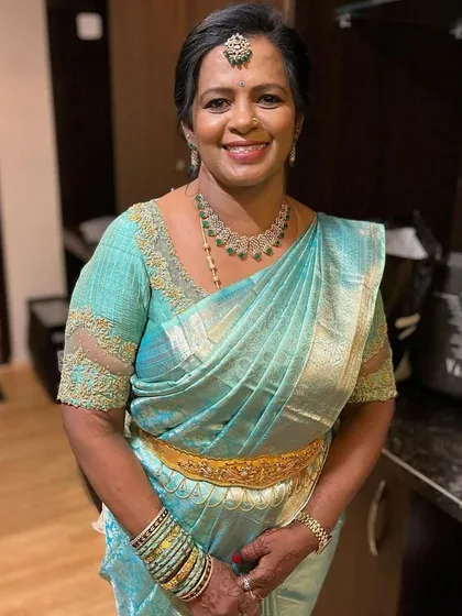 The mother of the groom should feel just as special. I was so happy to design this elegant light blue blouse with delicate net sleeves for the prettiest Gayathri aunty for her son's reception.