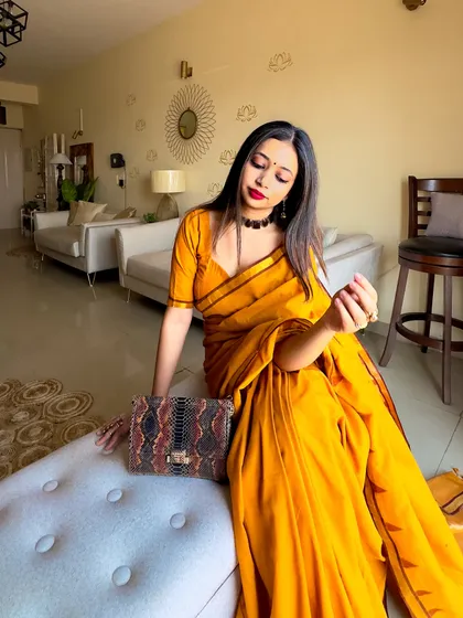 A final seated pose, showing how all the elements of the look come together. This is a great example of a beginner-friendly yet stunning saree look.