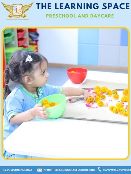 A child carefully sorts flower petals for a craft project. This simple task is great for developing fine motor skills, concentration, and an appreciation for natural beauty.