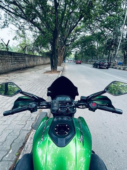 A wider look at the rider's point of view from the Dominar, showing the clean dashboard and comfortable handlebar setup.
