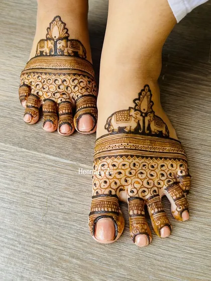 Don't forget the feet! I love creating adorable and elegant foot mehendi, like this symmetrical design featuring majestic elephants, to complete your bridal look from head to toe.