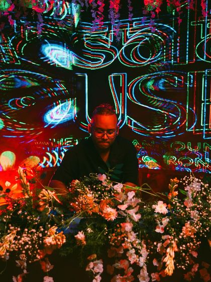 Another perspective from the Masala House launch, with the trippy visuals in the background. My setup is surrounded by flowers, adding to the unique theme of the night.