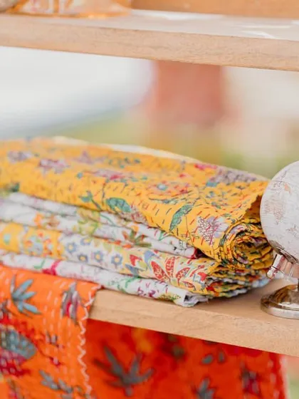Stacks of beautiful block-printed fabrics used as decor elements in our 'Rajasthani Folklore' theme.